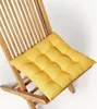 A yellow cushion on a wooden chair. Produktbild-Vorschau