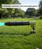 A cordless leaf blower is shown on a grassy lawn in a park setting. Produktbild-Vorschau