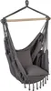 A hanging chair made of fabric and wood, suspended from a wooden bar. Podgląd zdjęcia produktu
