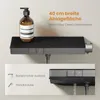 A shower system with a shelf and a soap dispenser is shown mounted on a wall. A close-up inset shows water flowing from the showerhead and a bottom outlet. Podgląd zdjęcia produktu
