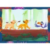 Two lion cubs and a bird are walking on a log in a forest. Produktbild-Vorschau
