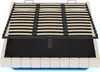 A bed frame with a slatted base lifted to reveal storage space underneath. Voir les images du produit