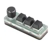 A small, programmable keyboard with a rotary encoder and three keys, presented on a white background. Podgląd zdjęcia produktu