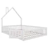 A white wooden house-shaped bed frame with a safety railing and a slatted base, shown from a diagonal angle against a white background. Produktbild-Vorschau