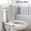 A bidet attachment is shown installed on a toilet in a bathroom setting. Produktbild-Vorschau