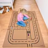 A young girl plays with toy cars on a road-themed playmat. Produktbild-Vorschau