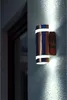 An outdoor wall light is mounted on a textured wall next to a window frame. Produktbild-Vorschau