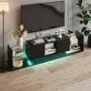 A modern living room setup featuring a TV stand with a television and various decorative items. Produktbild-Vorschau