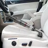 A handheld vacuum cleaner is being used to clean the interior of a car, specifically on the car seat. Produktbild-Vorschau