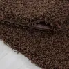 A close-up view of a brown shaggy rug, showing its texture and the edge where it is folded over. Anteprima dell’immagine prodotto