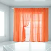 A room with a window covered by orange sheer curtains. Produktbild-Vorschau