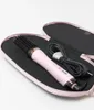 A pink hair dryer brush is placed inside its black and pink case. Produktbild-Vorschau