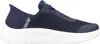 A side view of a navy blue Skechers slip-on sneaker with a white sole, isolated on a white background. Anteprima dell’immagine prodotto
