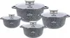 A set of four granite-coated pots with glass lids, arranged in a group on a white background. Anteprima dell’immagine prodotto