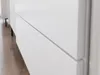 A close-up shot of a white dresser or cabinet with two drawers visible. Voir les images du produit