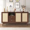 A wooden sideboard with rattan doors and drawers, decorated with framed pictures and decorative items on top, placed in a room. Produktbild-Vorschau