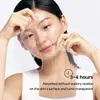 A woman is applying a clear sheet mask to her face. Produktbild-Vorschau