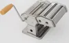 A stainless steel pasta maker with a tan handle on a white background. Náhled obrázku produktu
