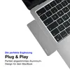 A close-up view of a MacBook laptop with a silver USB-C hub attached to its side, with marketing text overlayed on the left. Produktbild-Vorschau