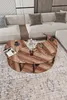 A modern living room scene with a sectional sofa and a unique yin-yang shaped coffee table. Produktbild-Vorschau