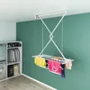 A laundry room with a washing machine, dryer, shelves, and a ceiling-mounted clothes drying rack with clothes on it. Náhľad obrázku produktu