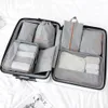 An open suitcase filled with packing cubes and bags. Voir les images du produit