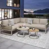An outdoor lounge set on a patio at dusk with a lake and mountains in the background. Produktbild-Vorschau
