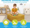 A young boy is playing with building blocks on a yellow folding mattress in a child's room. Produktbild-Vorschau