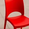 A close-up of a red plastic chair. Produktbild-Vorschau