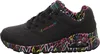 A side view of a black Skechers sneaker with a colorful heart pattern on the sole and inner lining. Náhled obrázku produktu
