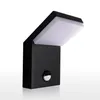 A black outdoor LED wall light with a motion sensor, shown against a white background. Produktbild-Vorschau