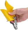 A hand holding a yellow dog muzzle with a gray strap. Produktbild-Vorschau