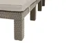 A close-up view of the legs and base of a wicker-style lounge chair with a cushion. Voir les images du produit