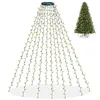 A Christmas tree light string draped over a white background, with a decorated Christmas tree in the background. Produktbild-Vorschau