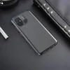 A dark, flat lay scene featuring a smartphone case and a notebook. Podgląd zdjęcia produktu