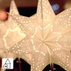 Close-up of a lit paper star lantern with intricate cutouts, suggesting a festive or decorative use. Produktbild-Vorschau