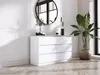 A white dresser with six drawers is shown in a room with a large mirror and a potted plant. Produktbild-Vorschau
