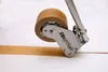 A close-up of a tape dispenser applying brown tape to a white surface. Produktbild-Vorschau