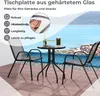 A table and chairs set on a patio with a view of the ocean. Voir les images du produit