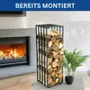 A modern living room with a fireplace and a metal firewood rack filled with logs. Produktbild-Vorschau