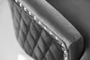 A close-up view of the armrest of a gray velvet chair, showing diamond tufting and decorative studs. Produktbild-Vorschau