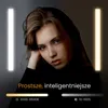 A portrait of a woman lit by two vertical lights, one on each side, with text and a color/brightness scale displayed at the bottom. Podgląd zdjęcia produktu