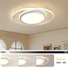 A modern LED ceiling light fixture with a sleek, abstract design, shown mounted on a ceiling. The image also includes a slider indicating brightness levels and three smaller images demonstrating different light color temperatures. Produktbild-Vorschau