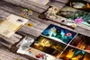 Board game components laid out on a wooden surface. Podgląd zdjęcia produktu
