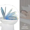 A toilet seat with a decorative print is shown in multiple stages of opening, next to a sleeping woman in bed. Produktbild-Vorschau