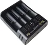 A close-up, angled view of a black battery charger with four slots for batteries. Produktbild-Vorschau