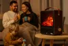 A family is gathered around a small electric fireplace in a cozy living room setting. Náhled obrázku produktu
