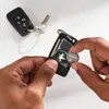 Hands replacing the battery in a car key fob. Anteprima dell’immagine prodotto