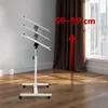 A white adjustable laptop stand is shown in a room with wooden floors and brown curtains. A red arrow points upwards next to text indicating height adjustment. Produktbild-Vorschau