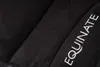 A close-up view of a black quilted saddle pad with white embroidered text. Produktbild-Vorschau